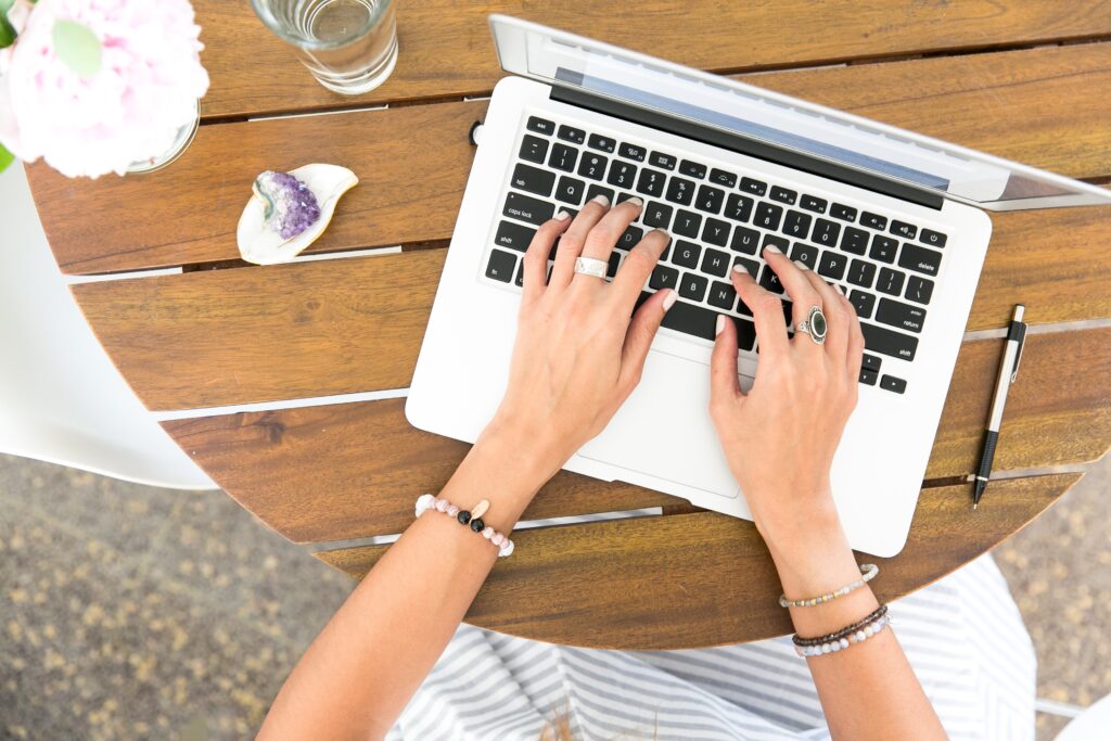 A person typing on a laptop computer.